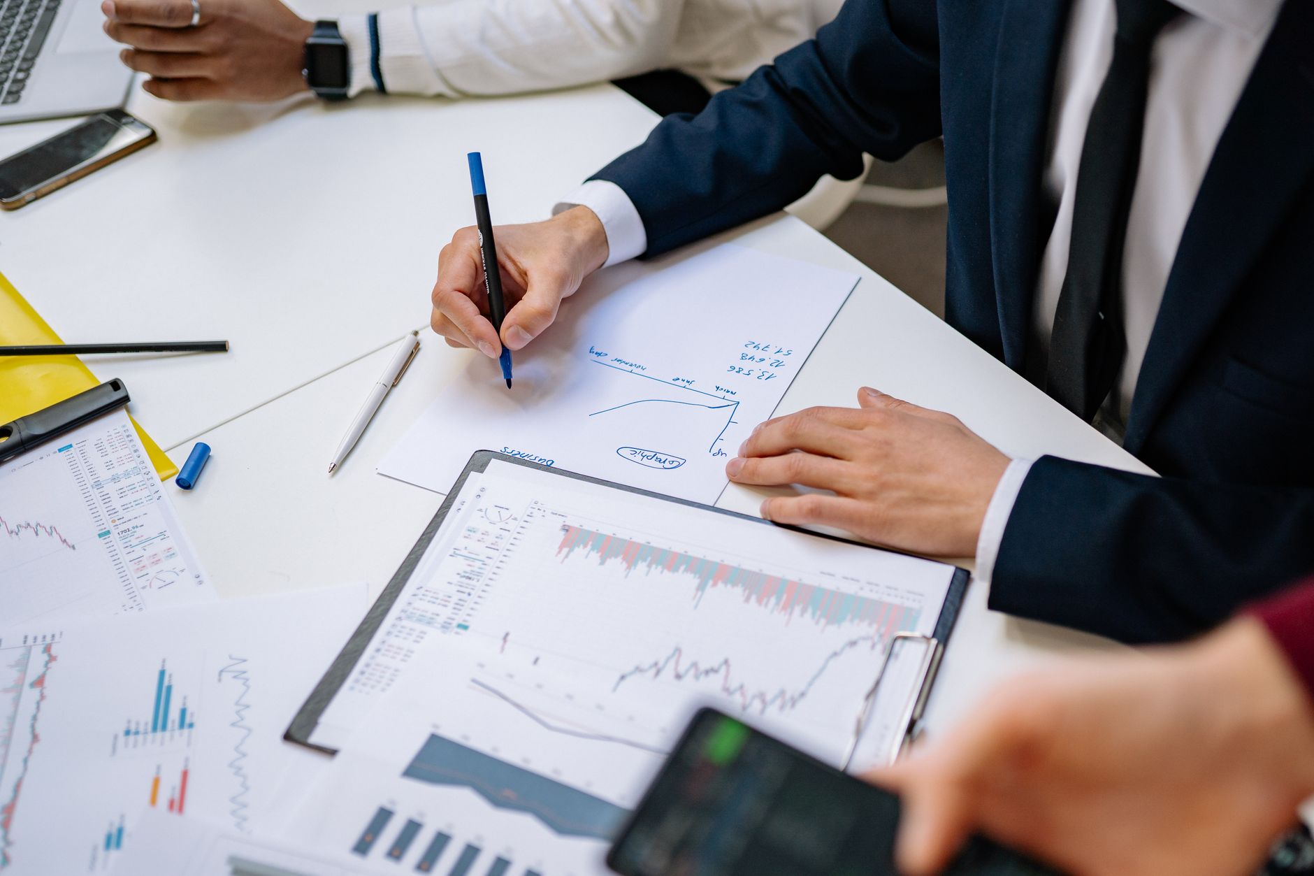 Professionals analyzing financial charts in a corporate setting. — Catch Weekend Games Without Cable via Sports Broadcast