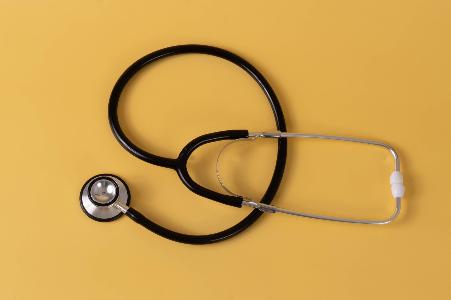 Close-up of a black stethoscope on a vibrant yellow surface, ideal for medical themes. — The Future of Healthcare: Medicare S