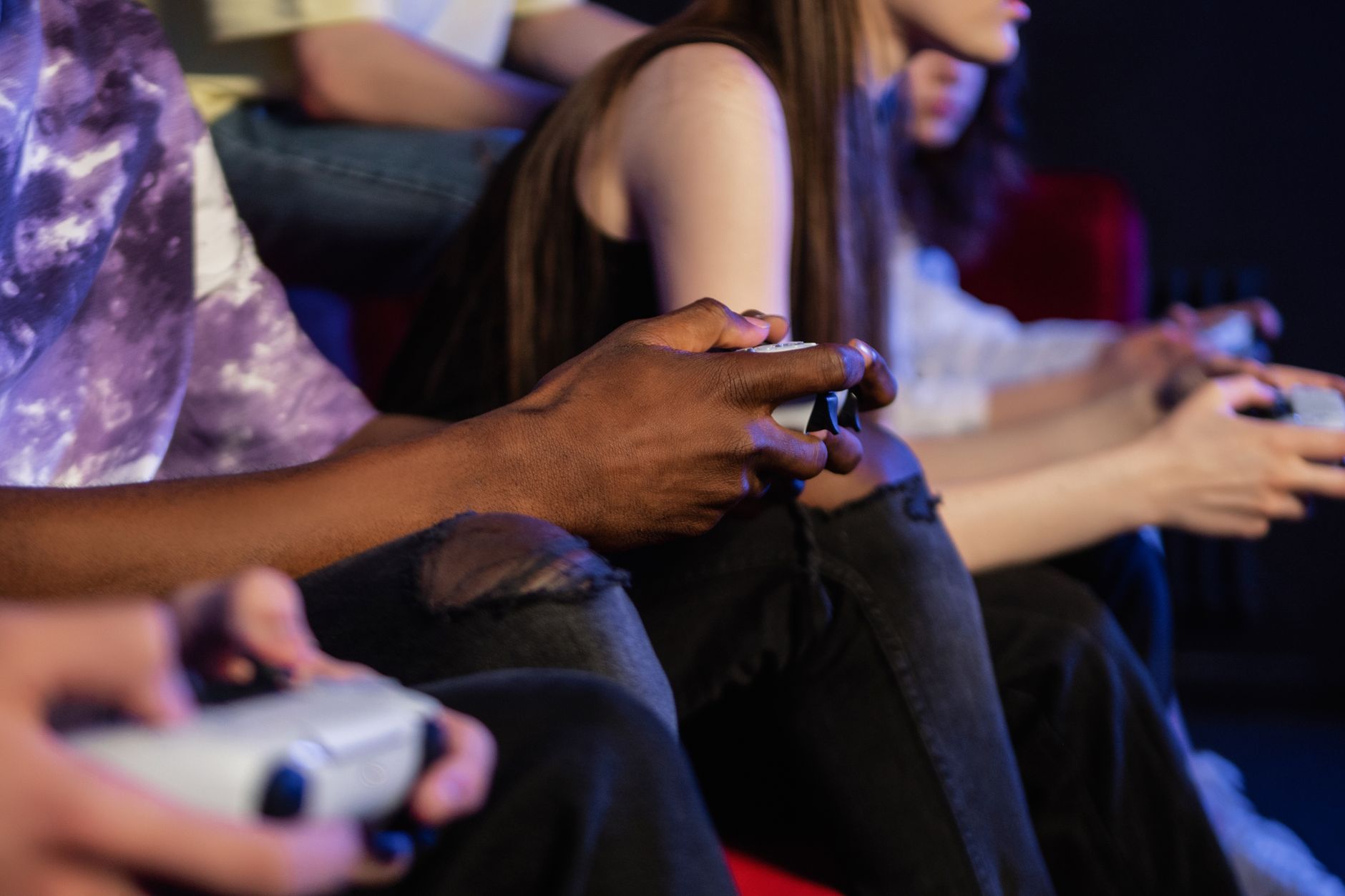 Teens playing video games with controllers, focused and engaged. — Winning Big with UFABET: Proven Betting Strategies