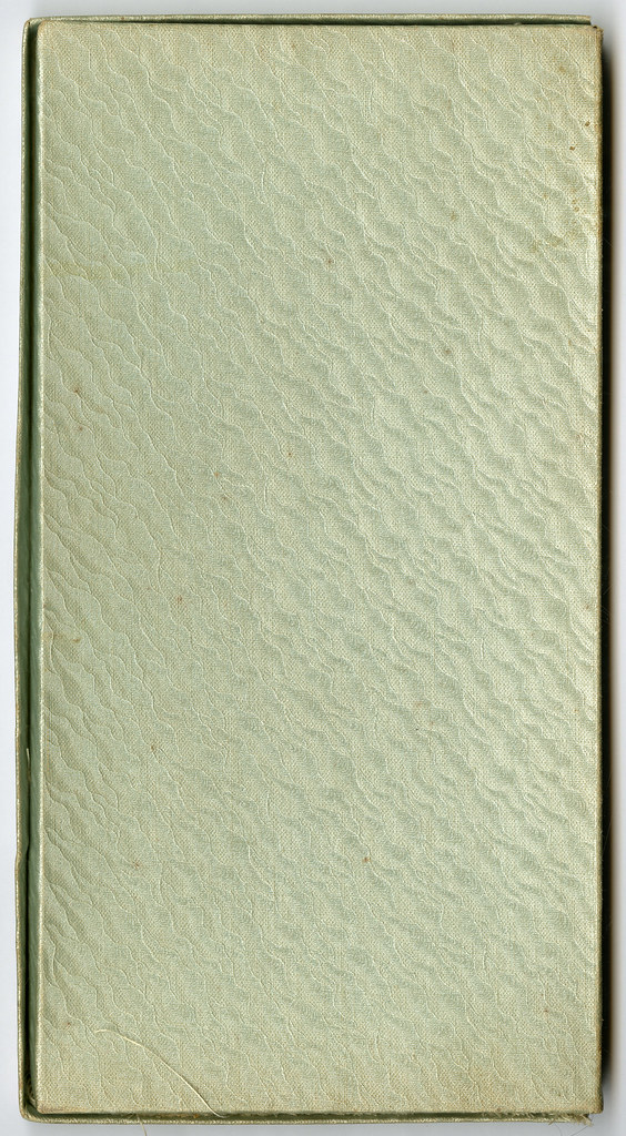 A closed green textured book or folder.